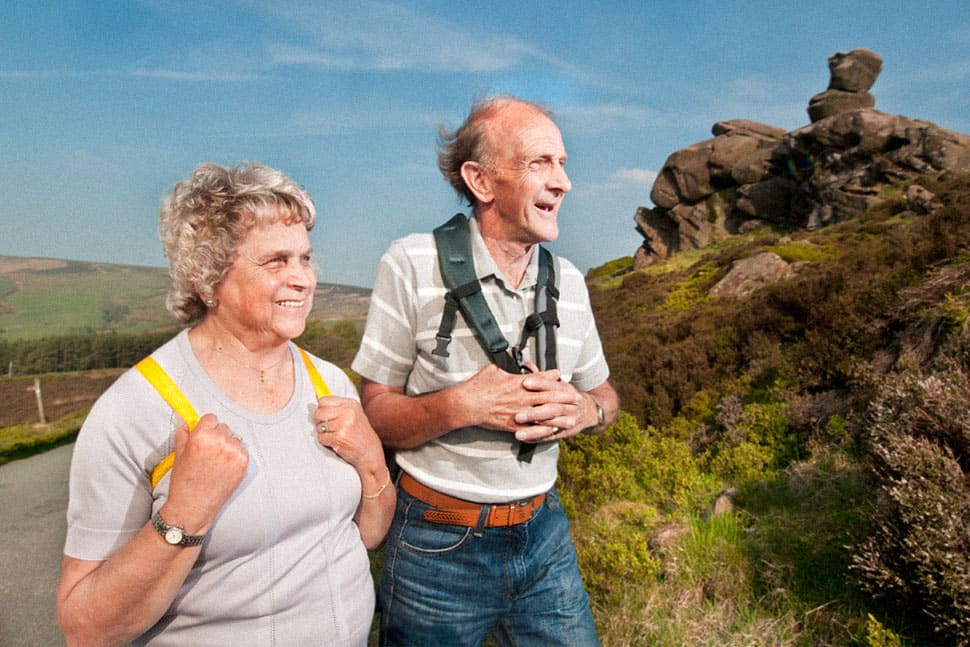 Two elderly people with backpacks